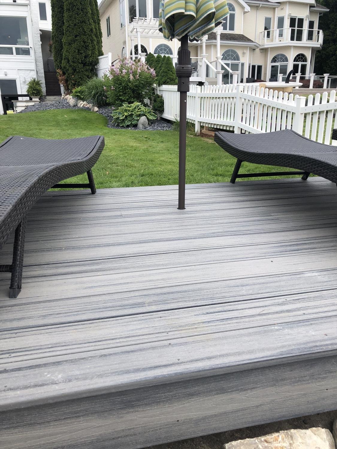 Umbrella pole mounted cleanly into a composite deck with Patio Buddy
