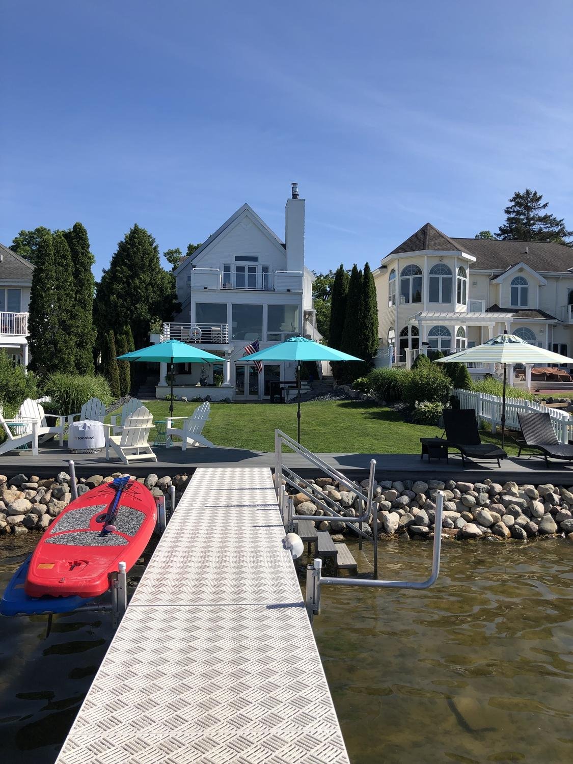 Lake house with mounted umbrellas seen from the dock
