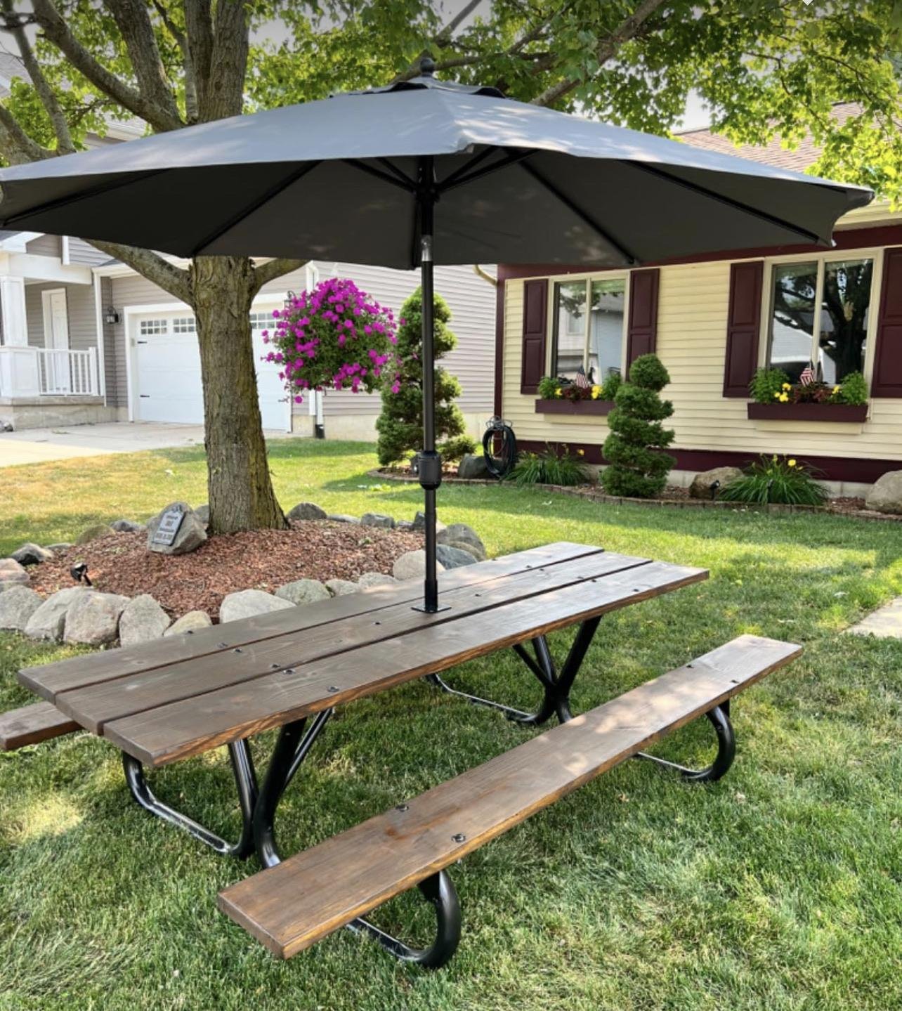 Backyard picnic table with mounted umbrella