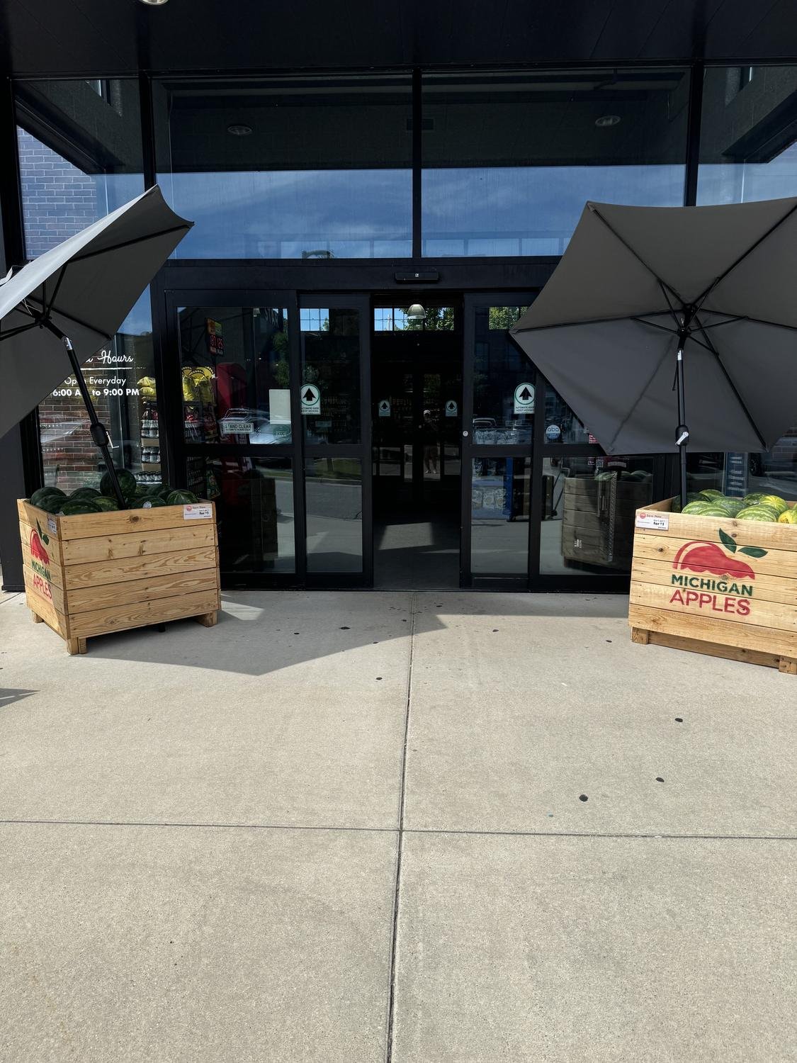 Store entrance with crate-mounted umbrellas