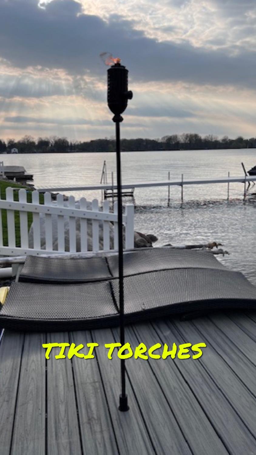 Tiki torch mounted in a deck sleeve